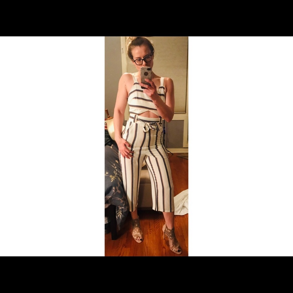 Pin striped overalls with mid section cut off.